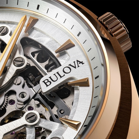Nahaufnahme einer Bulova-Uhr mit goldenen Akzenten und komplexem Uhrwerk.